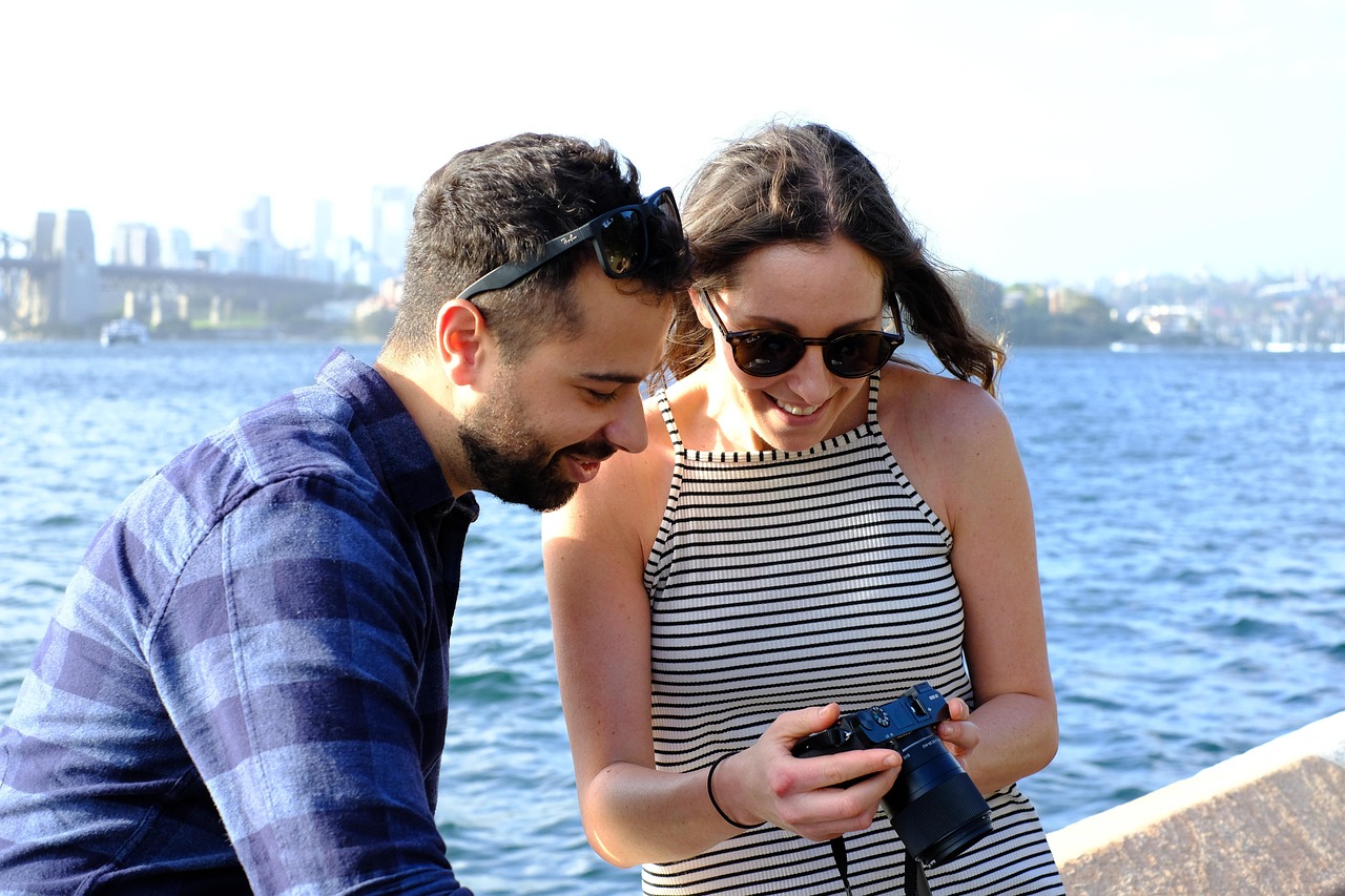 En esta imagen, vemos a una pareja visualizando las fotografías tomadas durante un viaje